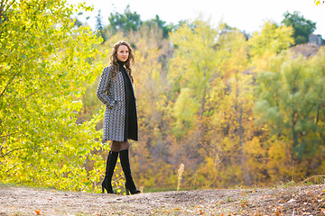 Image showing Young girl walking in the autumn forest