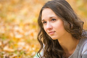 Image showing Close-up portrait of a beautiful young girl on the blurry background yellow foliage