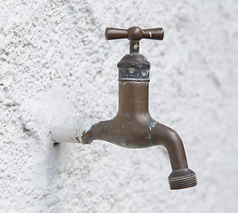 Image showing Old water tap on a white wall 