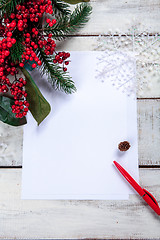 Image showing The blank sheet of paper on the wooden table with a pen 