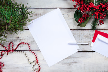 Image showing The blank sheet of paper on the wooden table with a pen 