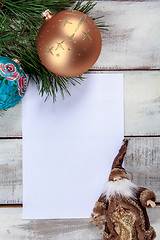 Image showing The sheet of paper on wooden table with Christmas decorations 