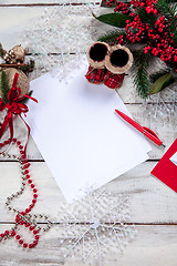 Image showing The blank sheet of paper on the wooden table with a pen 