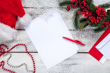 Image showing The blank sheet of paper on the wooden table with a pen 