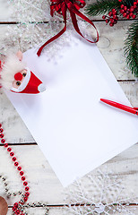 Image showing The blank sheet of paper on the wooden table with a pen 