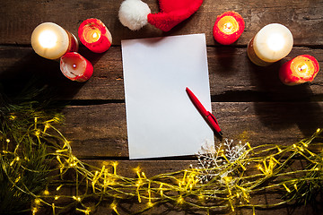 Image showing The blank sheet of paper on the wooden table with a pen 