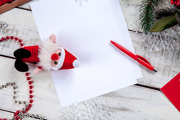 Image showing The blank sheet of paper on the wooden table with a pen 