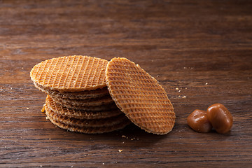 Image showing Waffles with caramel on wood