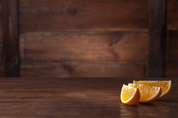 Image showing Orange slices on wood