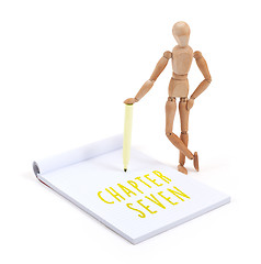 Image showing Wooden mannequin writing - Chapter seven