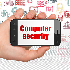 Image showing Protection concept: Hand Holding Smartphone with Computer Security on display