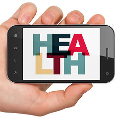 Image showing Health concept: Hand Holding Smartphone with Health on  display