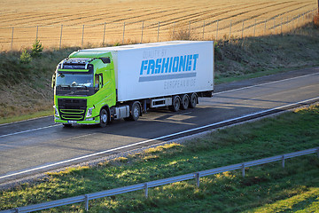 Image showing Lime Green Volvo FH Semi Truck on Motorway