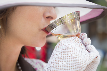 Image showing 1920s Dressed Girl with Hat, Gloves and Glass of Wine