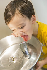 Image showing Mixed Race Boy Drinking From the Water Fountain