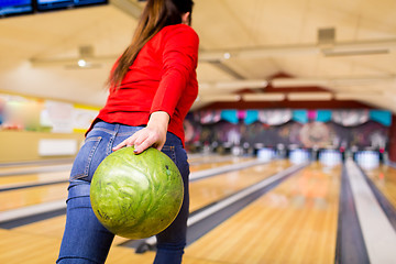 Image showing close up of woman throwing ball in bowling club