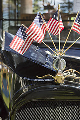 Image showing American Flags On Hood Ornament of Classic Car