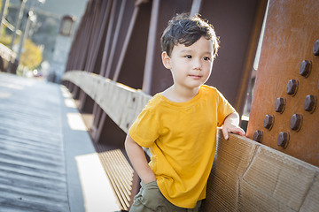 Image showing Mixed Race Boy Leaning on Bridge Outdoors