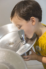 Image showing Mixed Race Boy Drinking From the Water Fountain