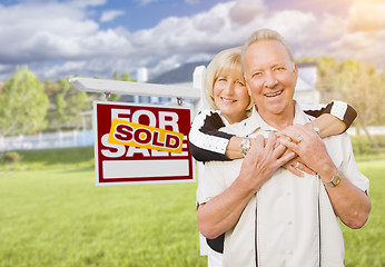 Image showing Senior Couple in Front of Sold Real Estate Sign and House