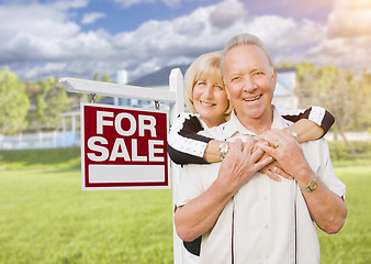 Image showing Happy Senior Couple Front of For Sale Sign and House