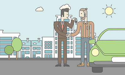 Image showing Car salesman giving the car keys to a new owner 