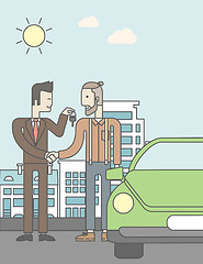 Image showing Car salesman giving the car keys to a new owner 