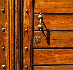 Image showing  knocker in a   closed wood door olgiate olona varese italy