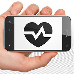 Image showing Health concept: Hand Holding Smartphone with Heart on display