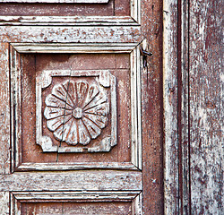 Image showing nail dirty stripped paint in the brown wood door and rusty  yell