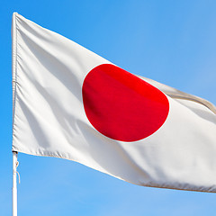 Image showing japanb waving flag in the blue sky bcolour and wave