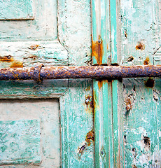 Image showing rusty metal     nail dirty stripped paint in the blue green