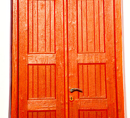 Image showing white  red brown  door in antique village santorini greece europ