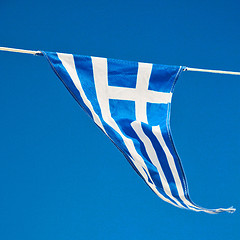 Image showing waving greece flag in the blue sky and flagpole