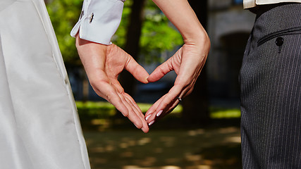 Image showing hands bride and groom in shape of heart