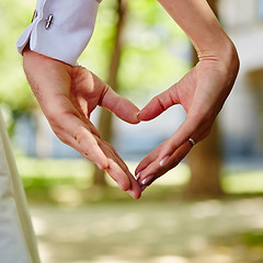 Image showing hands bride and groom in shape of heart