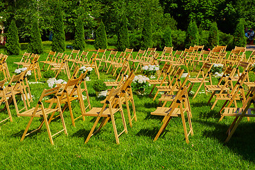 Image showing Rows of brown folding chairs