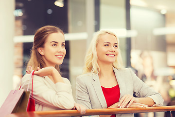 Image showing happy young women with shopping bags in mall