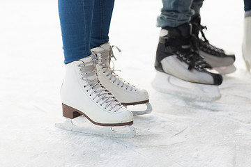 Image showing close up of legs in skates on skating rink