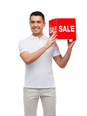 Image showing smiling man with red sale sigh