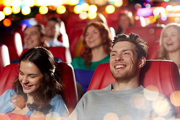 Image showing happy friends watching movie in theater