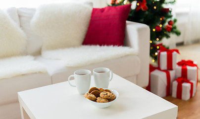 Image showing close up of christmas cookies and cups on table