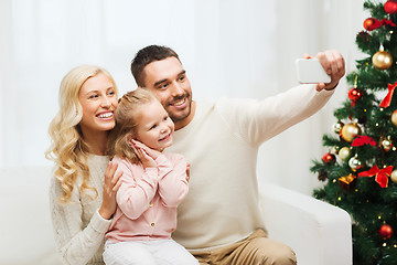 Image showing family taking selfie with smartphone at christmas