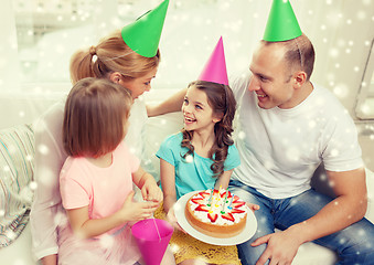 Image showing happy family with two kids in party hats at home