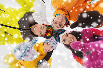 Image showing happy friends in winter clothes outdoors