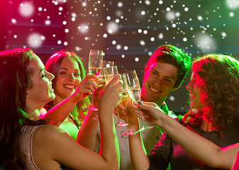 Image showing smiling friends with glasses of champagne in club