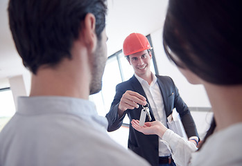 Image showing couple buying new home with real estate agent