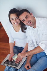 Image showing relaxed young couple working on laptop computer at home