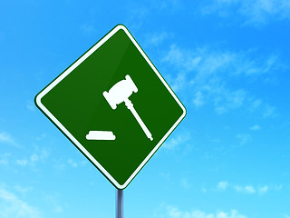 Image showing Law concept: Gavel on road sign background