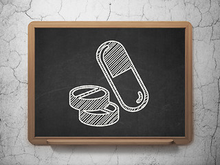 Image showing Healthcare concept: Pills on chalkboard background